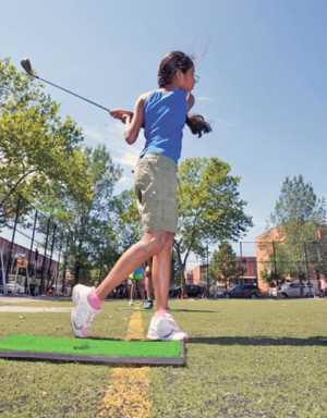 Children learn how to play golf