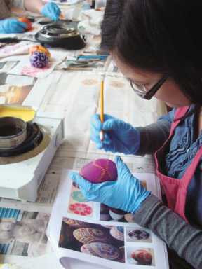 Visitors learn the time-honored Ukranian method of dying Easter eggs