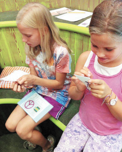 Children learn sewing crafts.