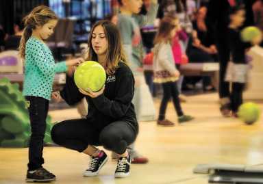 Children enjoy bowling, face painting, and games at the annual Bowlopolis Blastoff