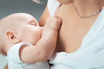 Baby feeds on MOM’s breasts