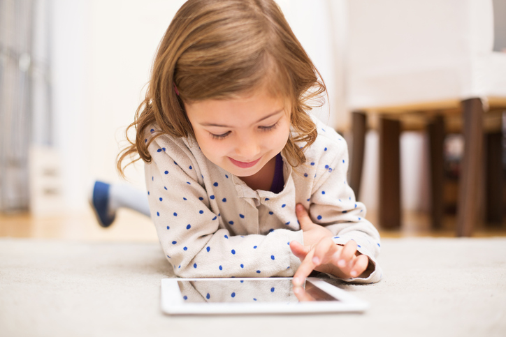 Little girl learning using digital tablet