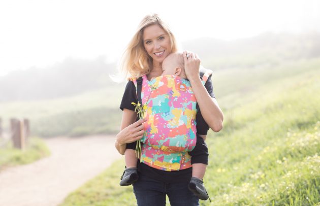 Mother wearing Oh Joy! x Baby Tula carrier with baby inside
