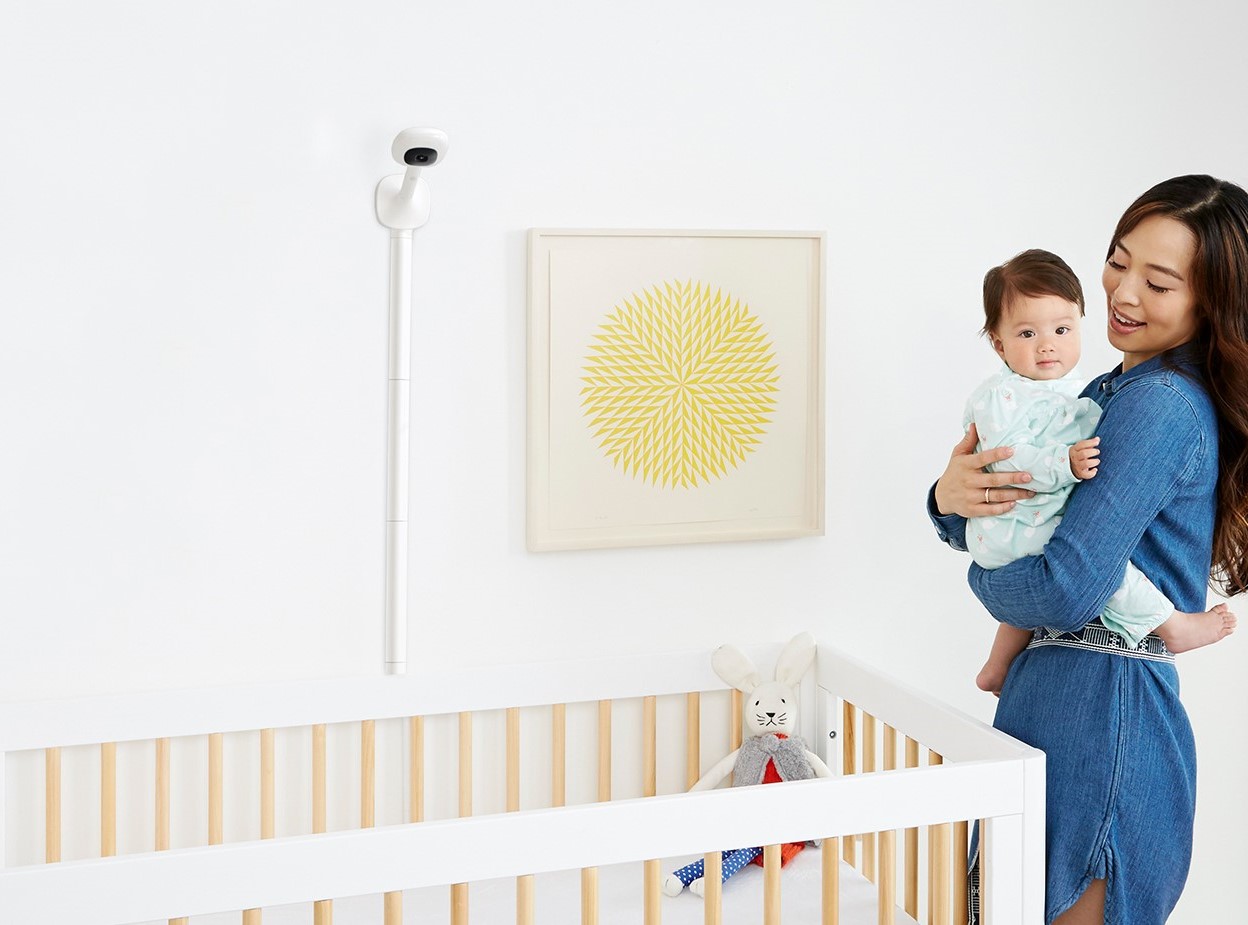Mother with baby in nursery with Nanit smart montior