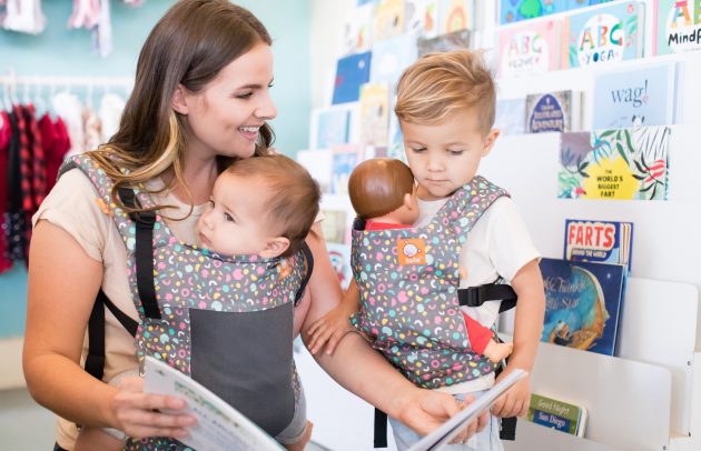 Mother shopping while wearing an Oh Joy! x Baby Tula baby carrier