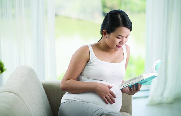 pregnant woman reading a book