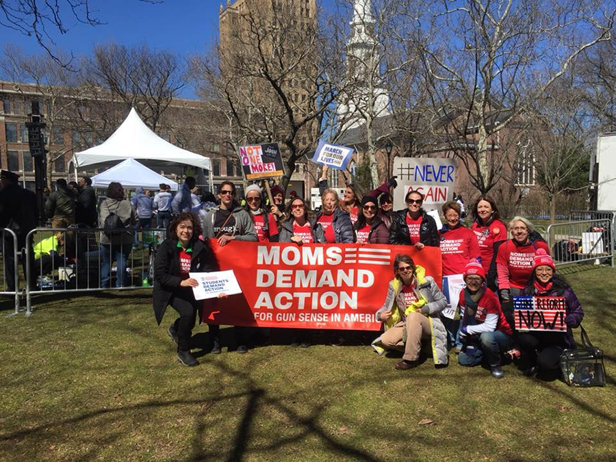 Moms Demand Action members around sign