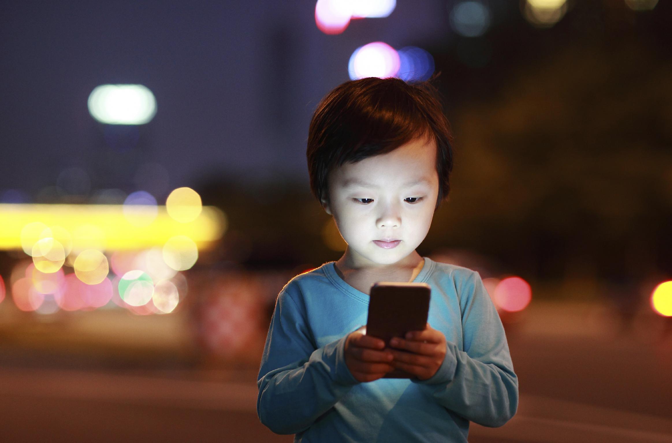 young child using iphone
