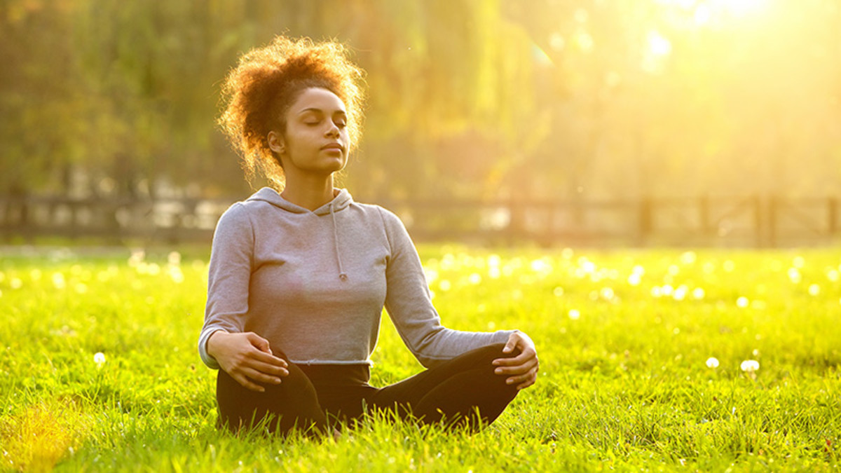 woman meditating outdoors