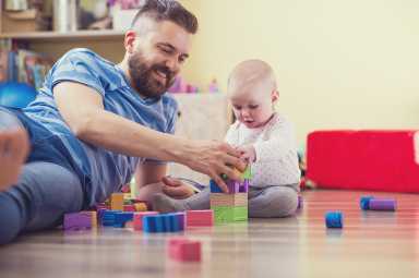 Young hipster father playing with his daughter
