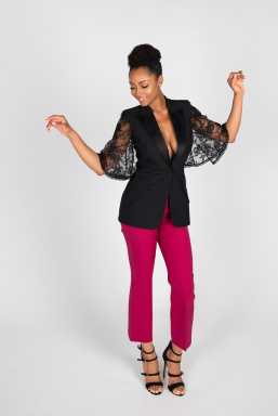 Actress Yayay DaCosta wearing pink pants and black top, dancing