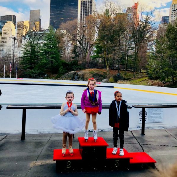 three girls at figure skating competition