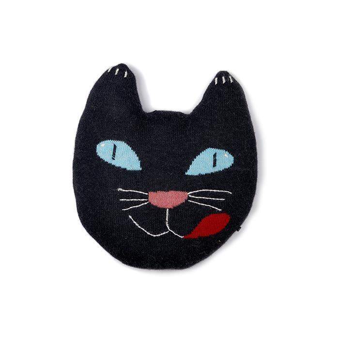 knit pillow shaped like the face of a black cat