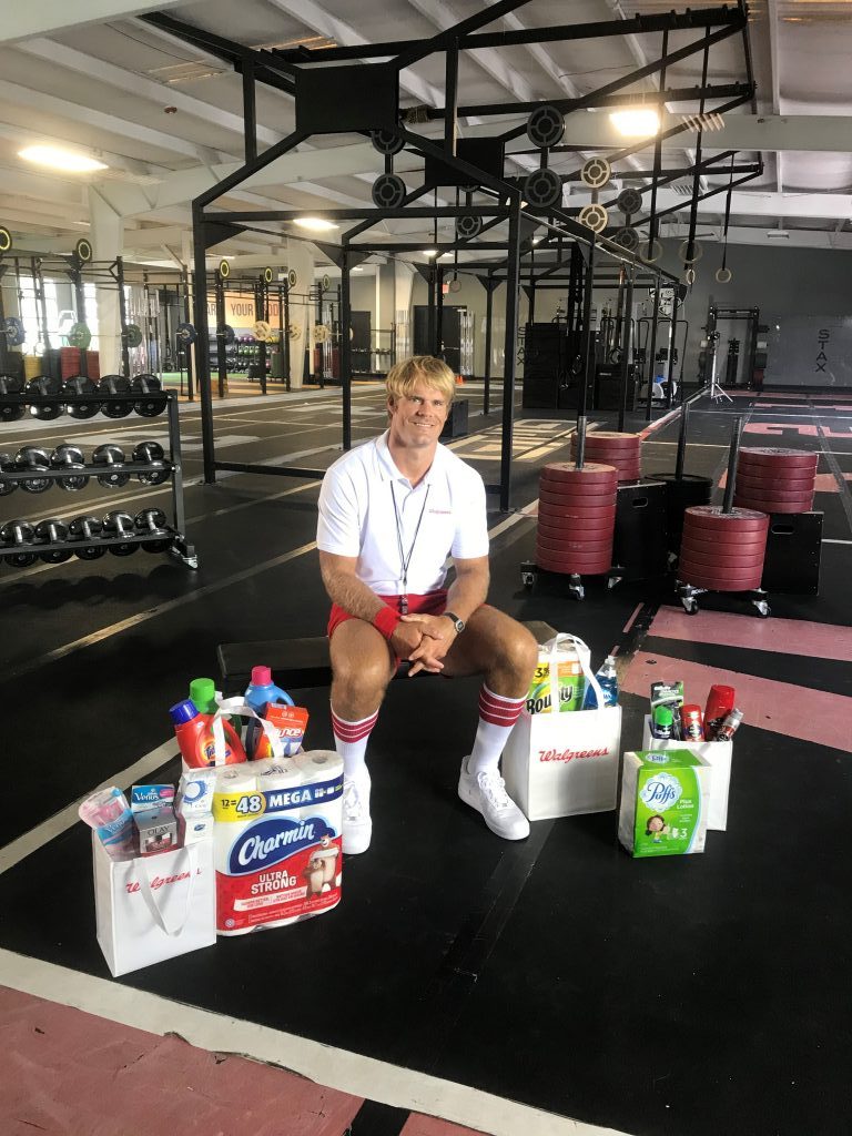 greg olsen sitting inside gym with p&g products