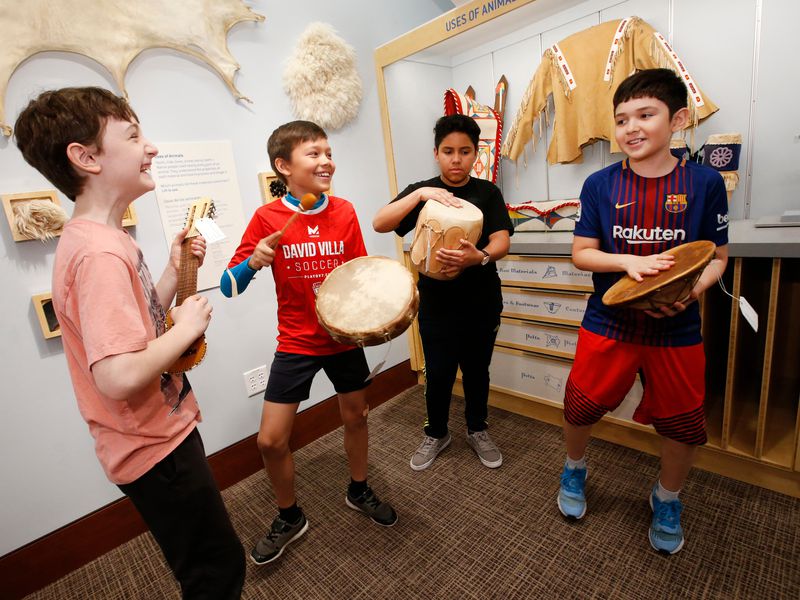 group of boys playing different instruments made by native americans
