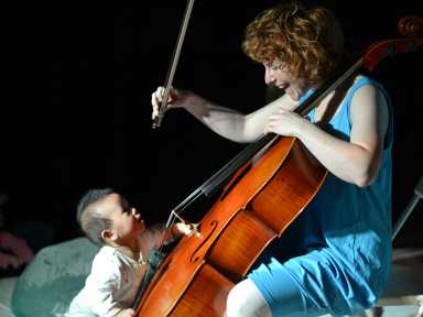 baby touches cello with female cellist