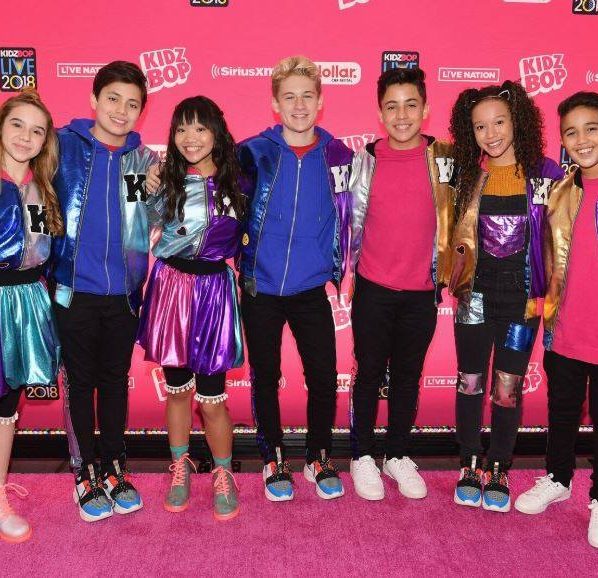 group of hip kids on a pink step and repeat
