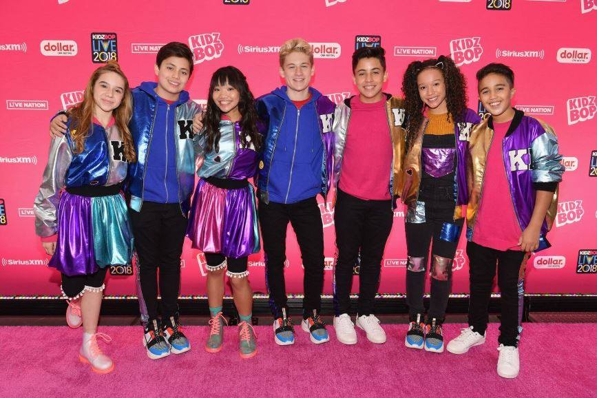 group of hip kids on a pink step and repeat