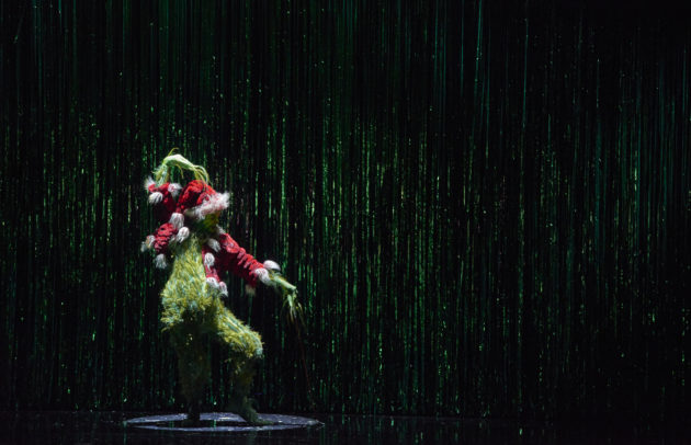 actor dressed as the grinch in a muscial of the popular christmas book