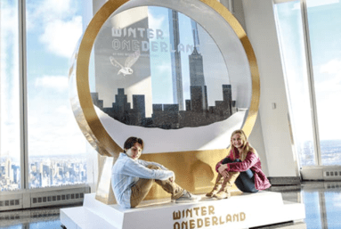 children in front of giant snowglobe