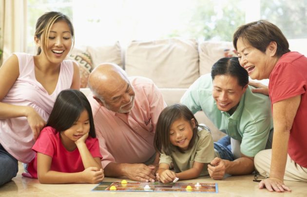 asian family playing a board game