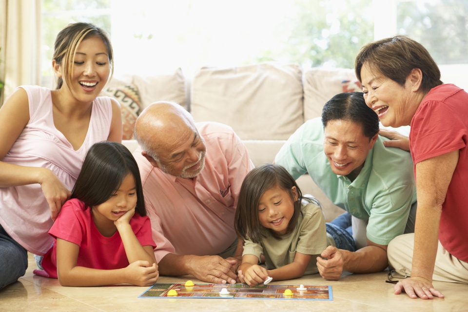asian family playing a board game
