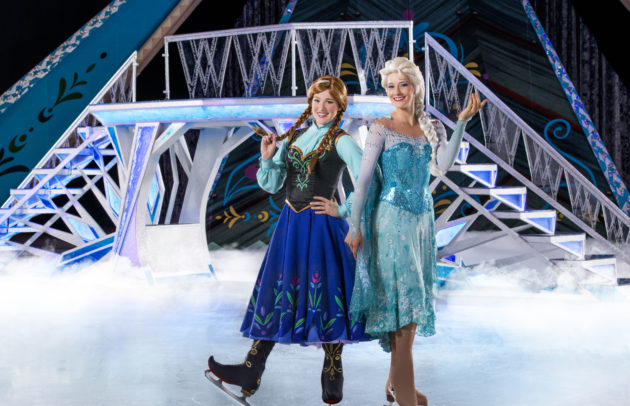 elsa and anna skating on ice during a frozen performance