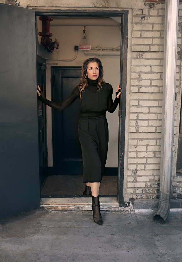 woman standing in brick doorway