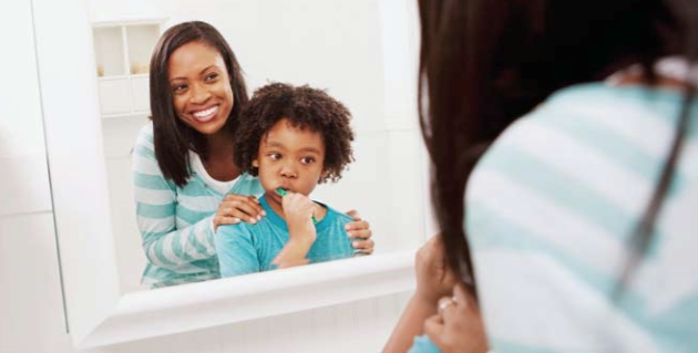 mother and child brushing their teeth