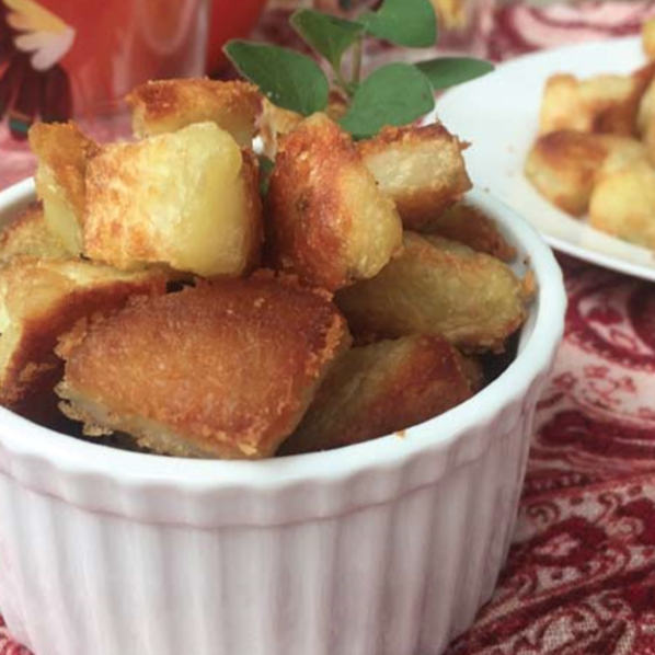 crispy potatoes in a white dish on a red table cloth