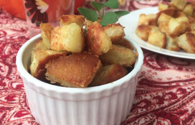 crispy potatoes in a white dish on a red table cloth