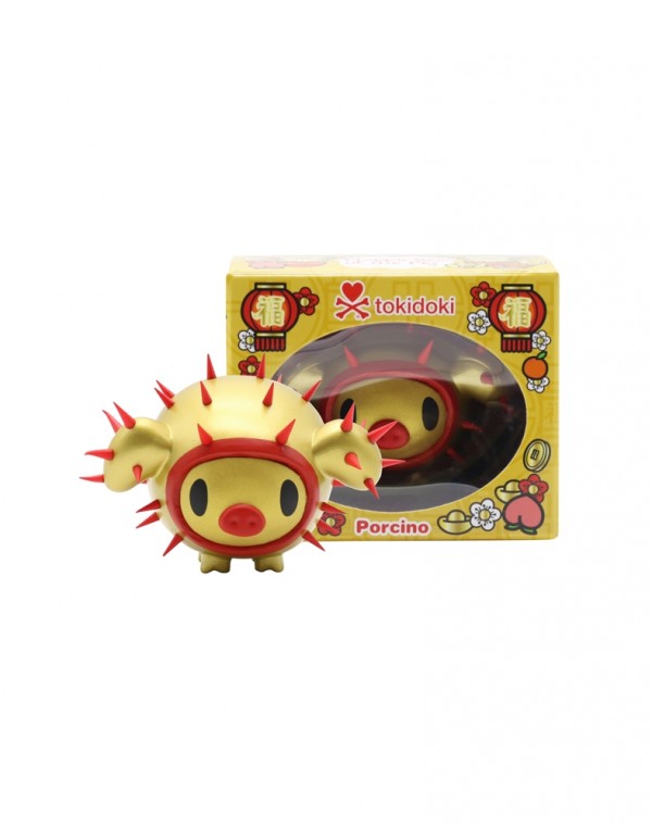 red and gold spiky pig collectible toy next to box