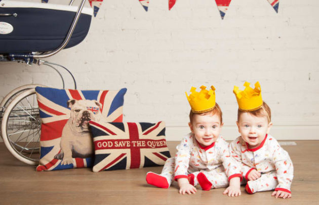 two cute babies in british inspired onesies