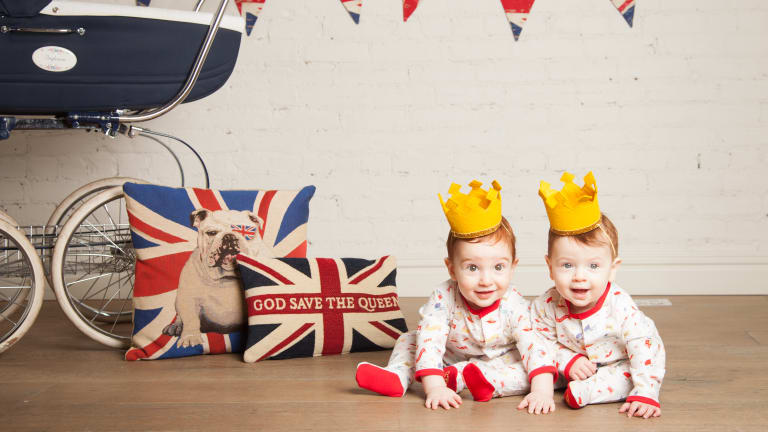 two cute babies in british inspired onesies
