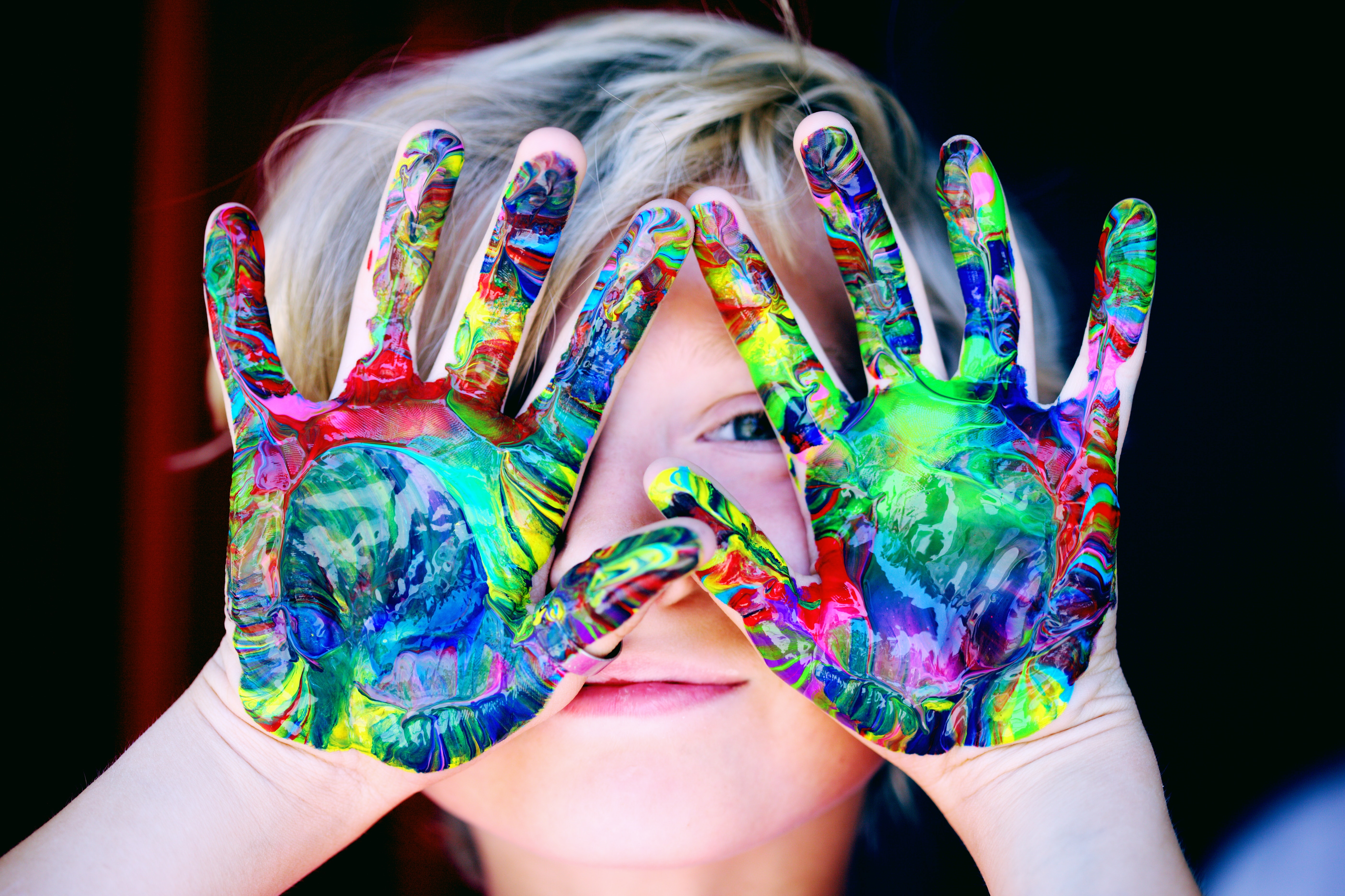 kids with paint colors on hands