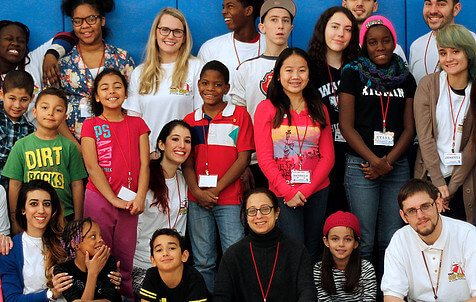 Kids on bleachers cheesing for the camera at Camp Good Grief