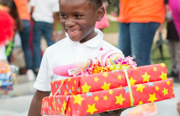 kid holding presents