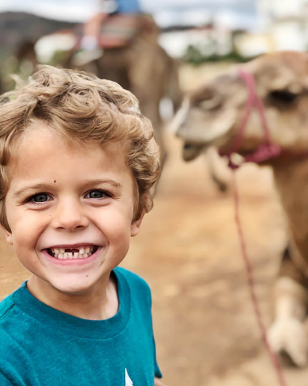 young boy with a camel 