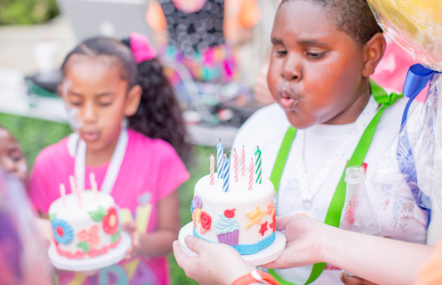 kids blowing out birthday candles