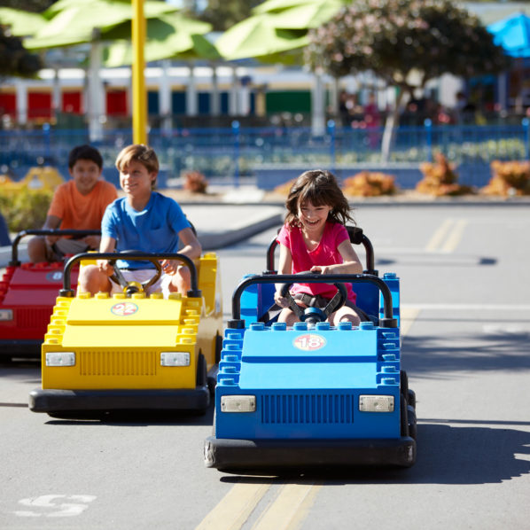 Kids driving LEGO vehicles down a track at LEGOLAND New York