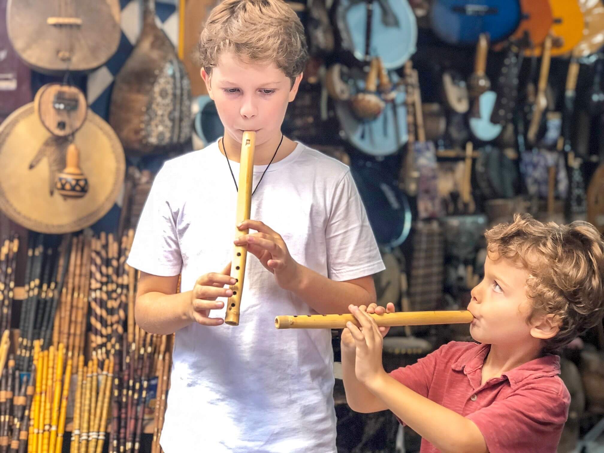 two young boys playing flutes