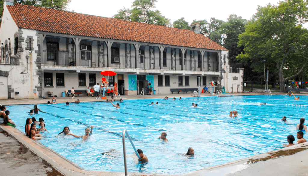 Children and parents play in the water at Faber Pool.