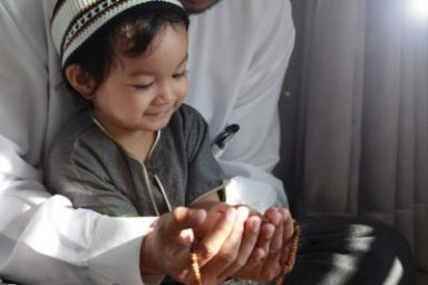 Ramadan guide NYC, girl and adult cup hands