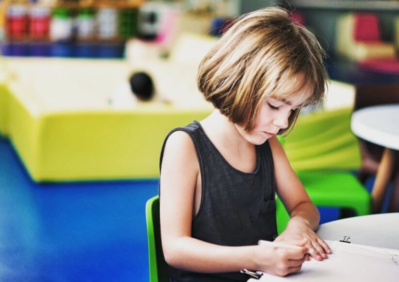 young girl sitting at desk