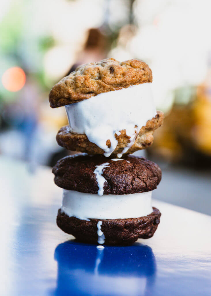 two ice cream sandwiches stacked on top of each other on a table begin to melt
