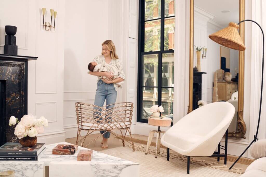 a woman holds her baby in a nursery, maisonette