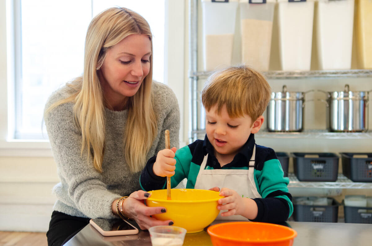 kid with mother cooking