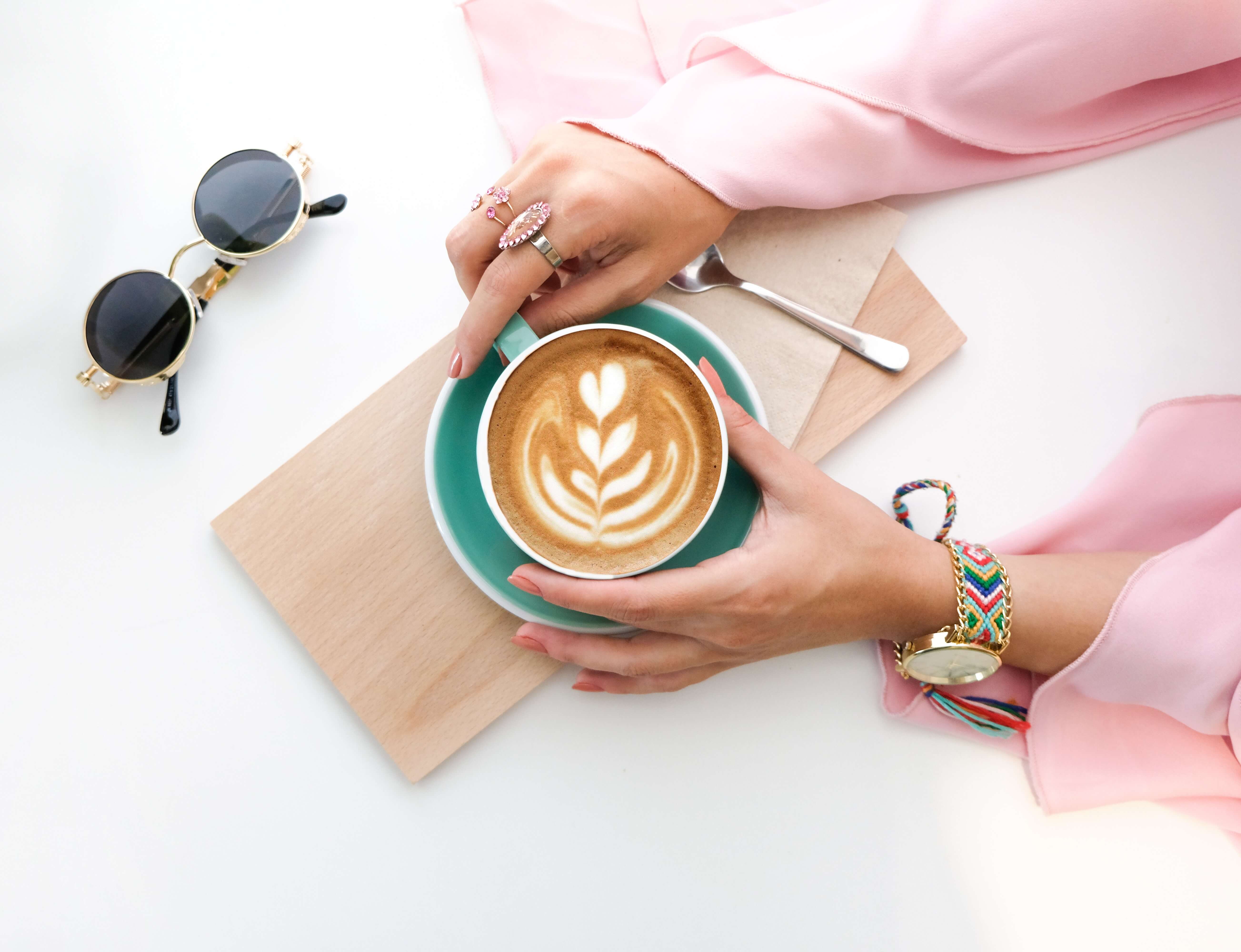 woman-holding-cup-of-latte-1260591