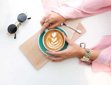 woman-holding-cup-of-latte-1260591