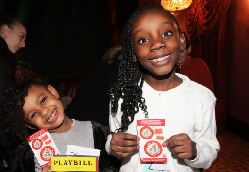 kids holding their broadway tickets at kid's night on broadway